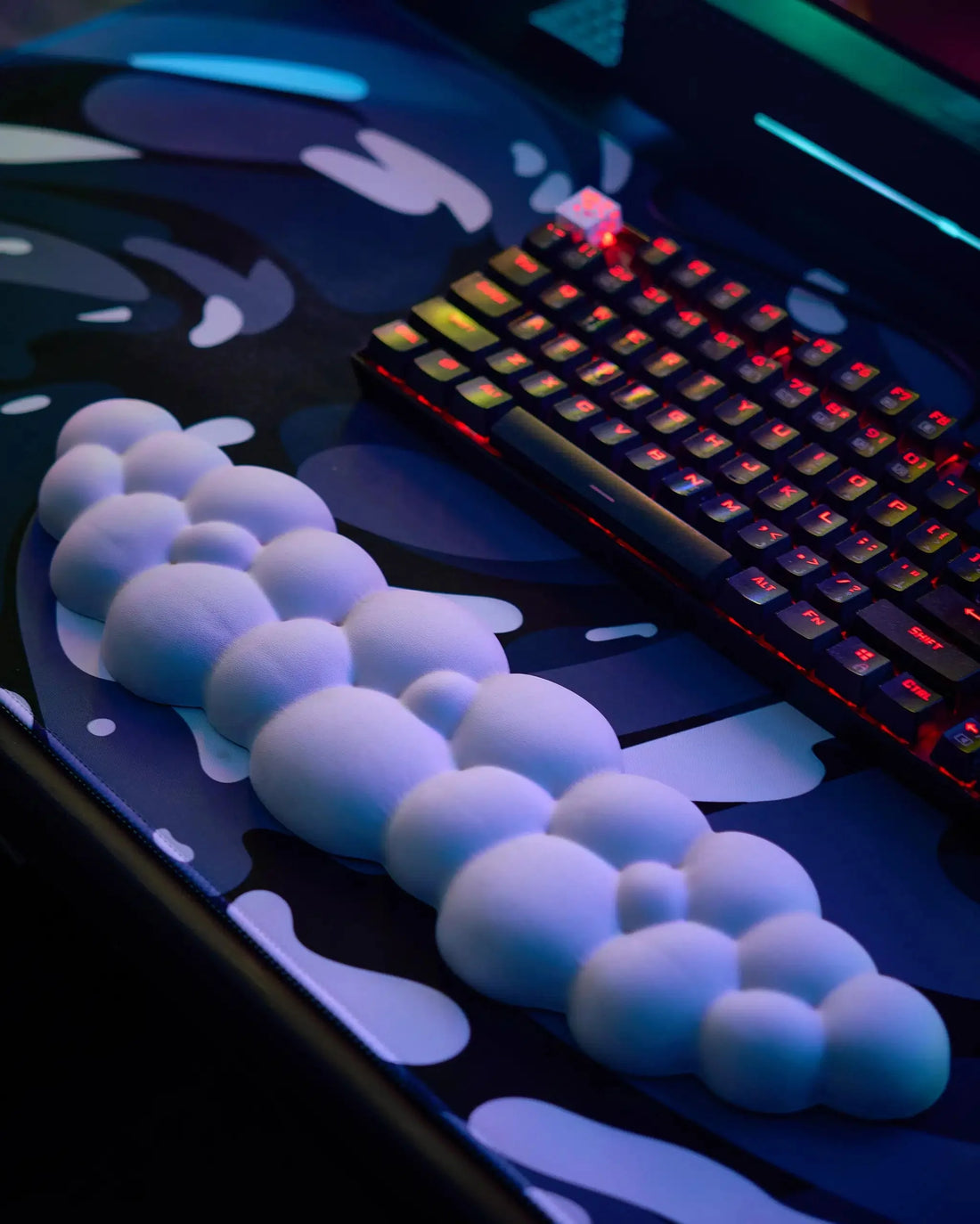 Cloud-shaped wrist rests positioned in front of a keyboard and mouse