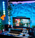 Example gaming desk setup with a white RGB pegboard, wall shelf and plants in warm lighting