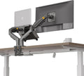 Gas-spring monitor arm clamped to a desk edge holding a screen